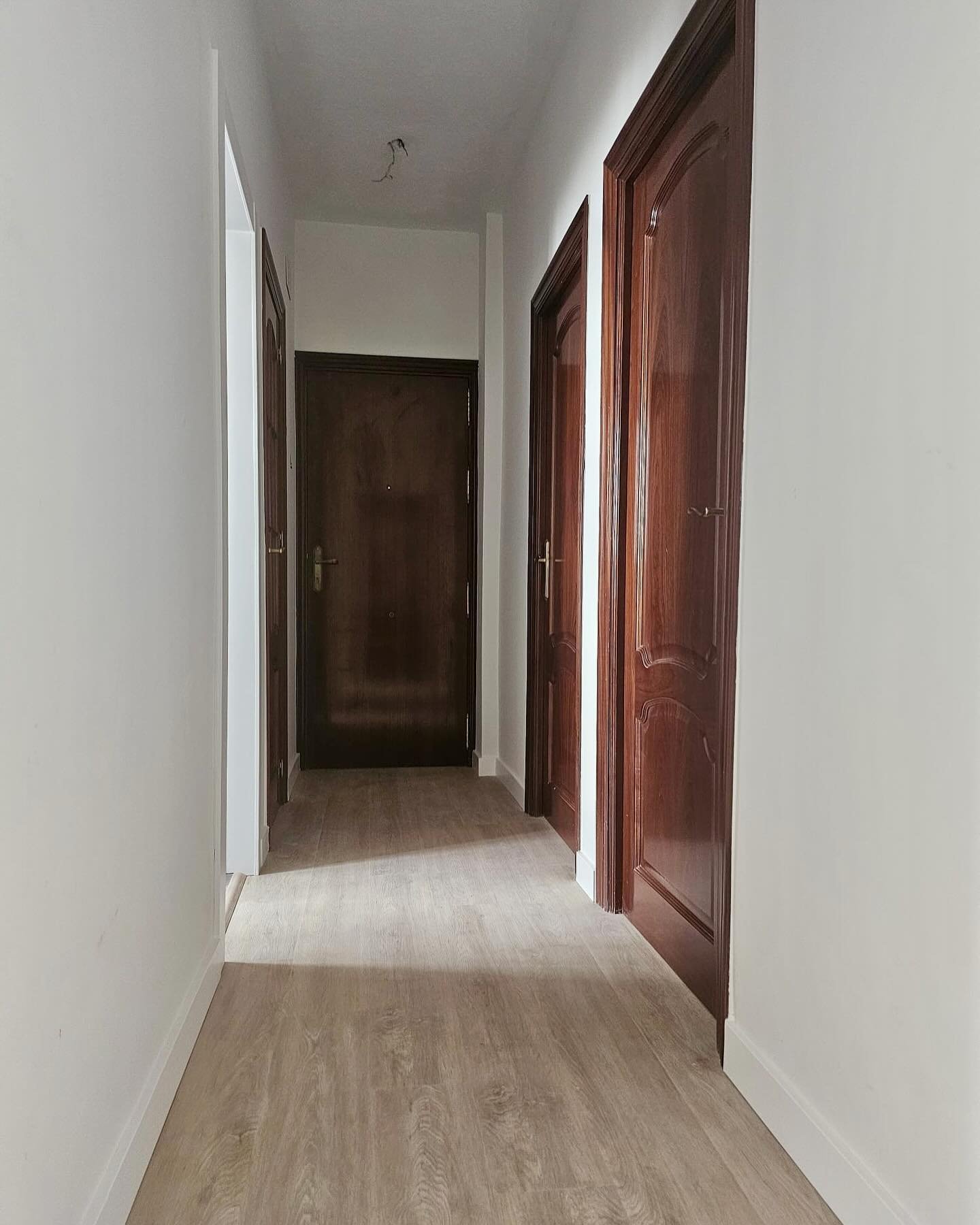 Pasillo después: suelo laminado en tono roble claro